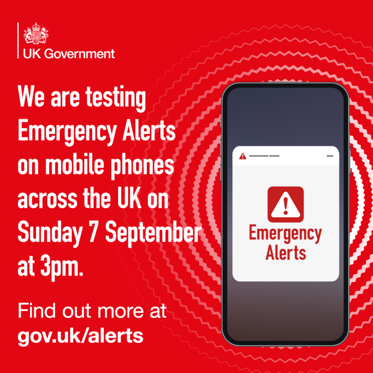 Red background with a picture of the UK Government logo in the top left. Below this is white text reading 'We are testing emergency alerts on mobile phones across the UK on Sunday 7 September at 3pm. Find out more at gov.uk/alerts'. To the right of this text is a picture of a smart mobile phone with a red warning triangle in the centre and below this text saying 'Emergency Alerts'